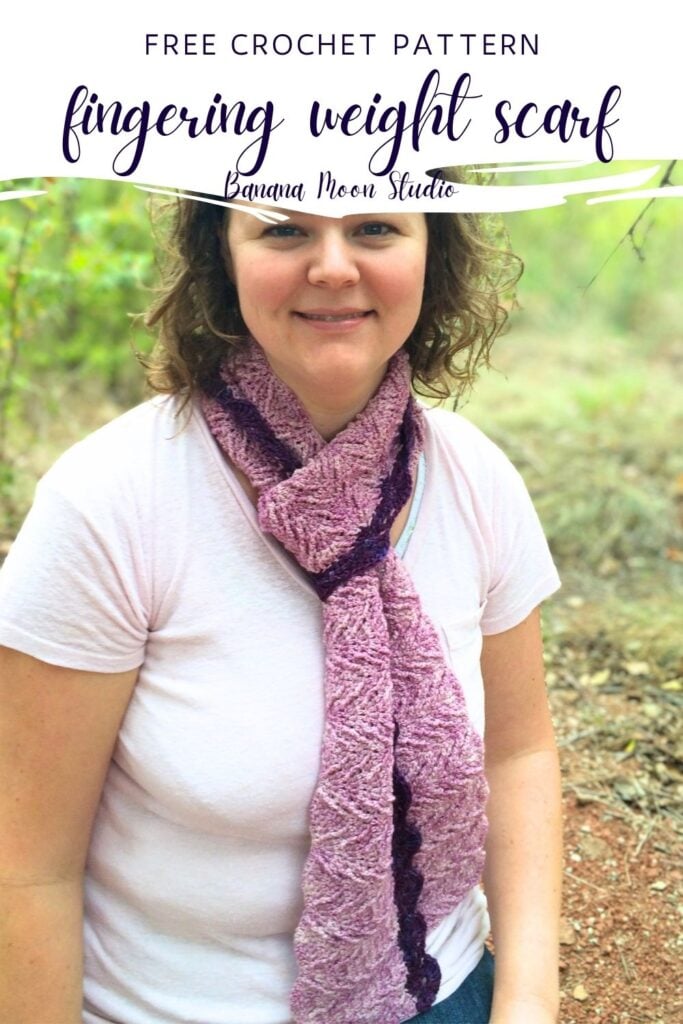 A woman stands outside wearing a textured, purple crochet scarf looped around her neck. A panel with text reads: Free crochet pattern, fingering weight scarf, banana moon studio