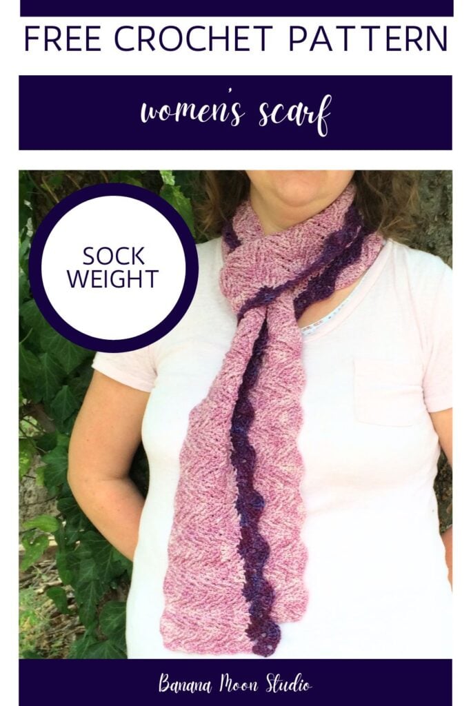 A woman stands with her back against a tree trunk. She is wearing a purple, textured crochet scarf around her neck. Panels with text read: Free crochet pattern, women's scarf, sock weight., Banana Moon Studio.