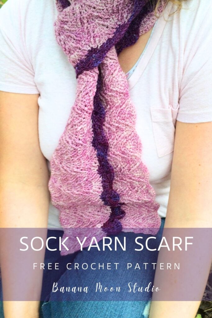 A woman wearing a textured crochet scarf in two shades of purple. A panel with text reads: Sock yarn scarf free crochet pattern, Banana Moon Studio.