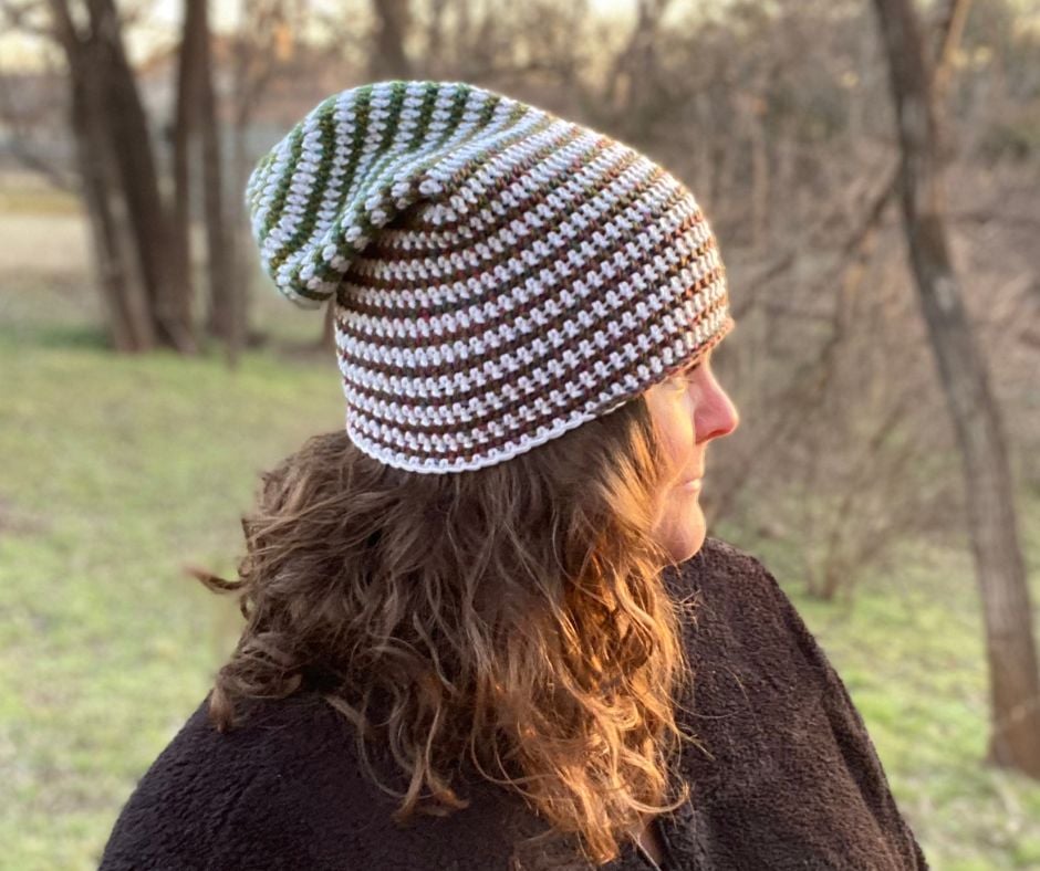 A woman stands outside wearing a striped slouchy crochet beanie and a black jacket. Text on the image reads: Banana Moon Studio.