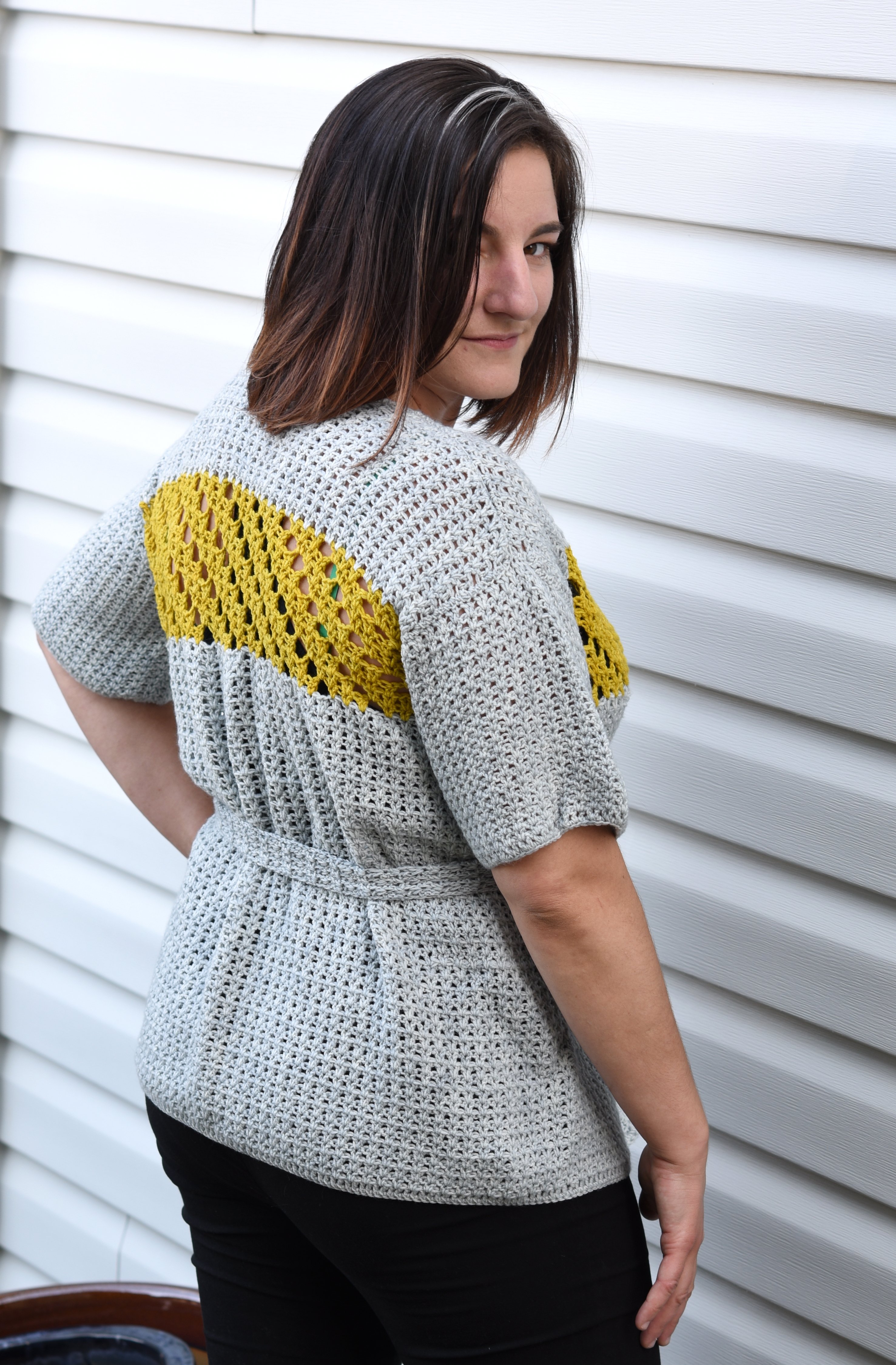 Jessamine Cardigan, a crochet pattern from Banana Moon Studio and Ancient Arts. Back view with belt closure