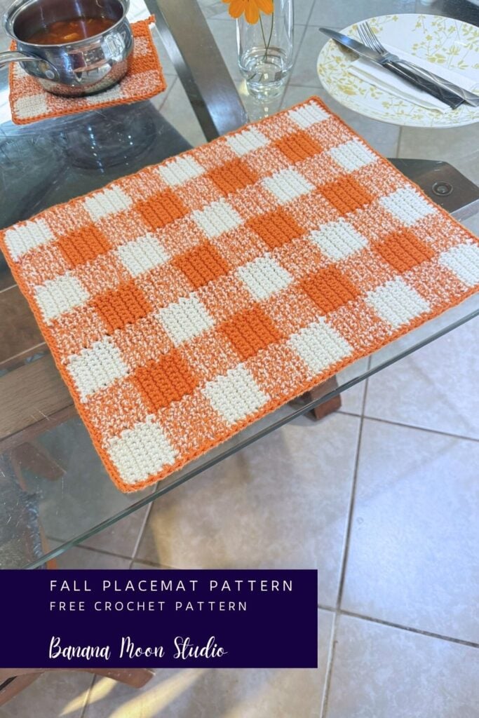 Fall gingham crochet placemat on a glass table top. A panel with text reads: Fall placemat pattern, free crochet pattern, banana moon studio.