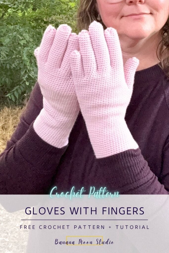 A woman wears pink crochet gloves with fingers. A panel with text reads: crochet pattern, gloves with fingers free crochet pattern + tutorial, banana moon studio.