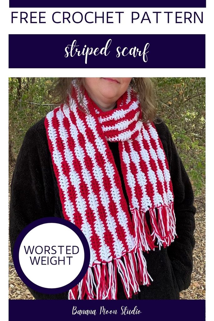 A woman stands outside wearing a striped crochet scarf with fringe on the ends over a black jacket. Panels with text read: free crochet pattern, striped scarf, worsted weight, banana moon studio.
