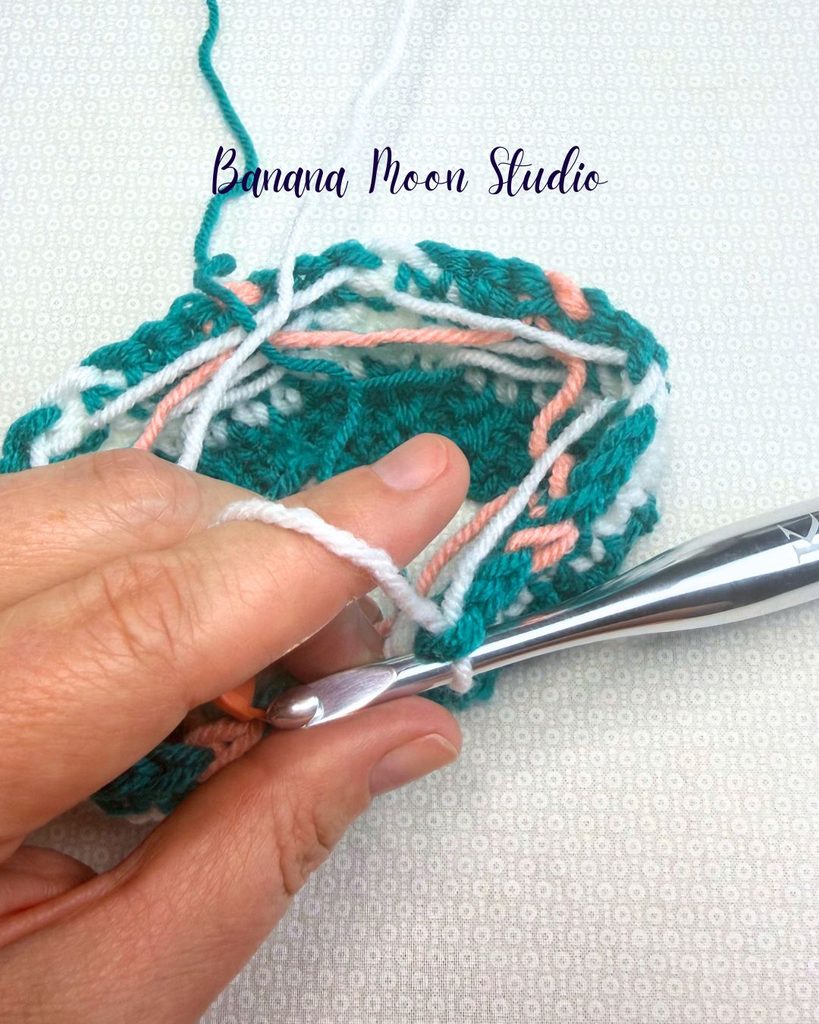 Photo showing a fair isle crochet hat project with several yarn floats across the wrong side. Text on the image reads: Banana Moon Studio.